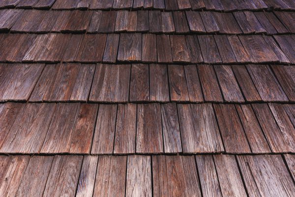 Worn wooden roof tile pattern, detail of a typical old slovenian alpine cottage roofing as background